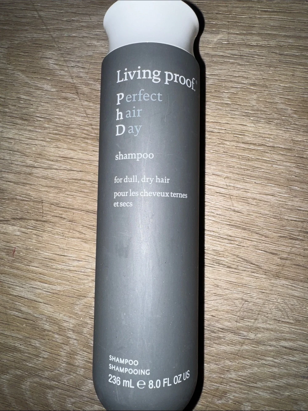 Living Proof shampoo bottle in black and white